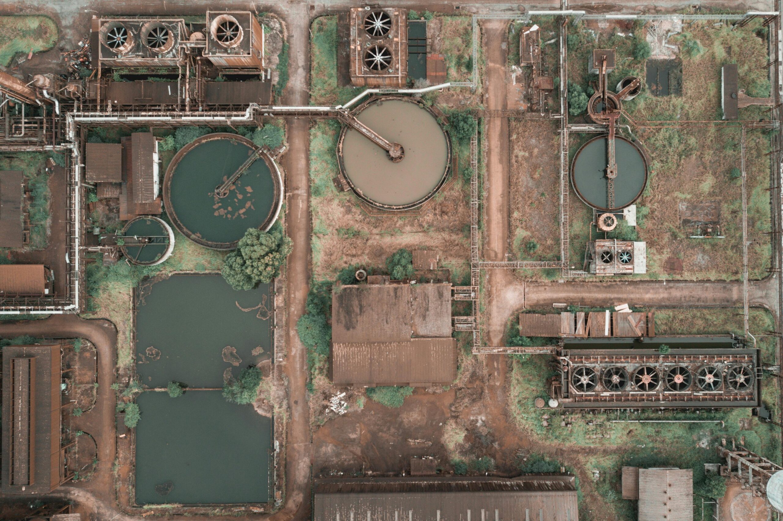 ABOUT US Aerial view of an industrial water treatment plant showcasing clarifiers and tanks.